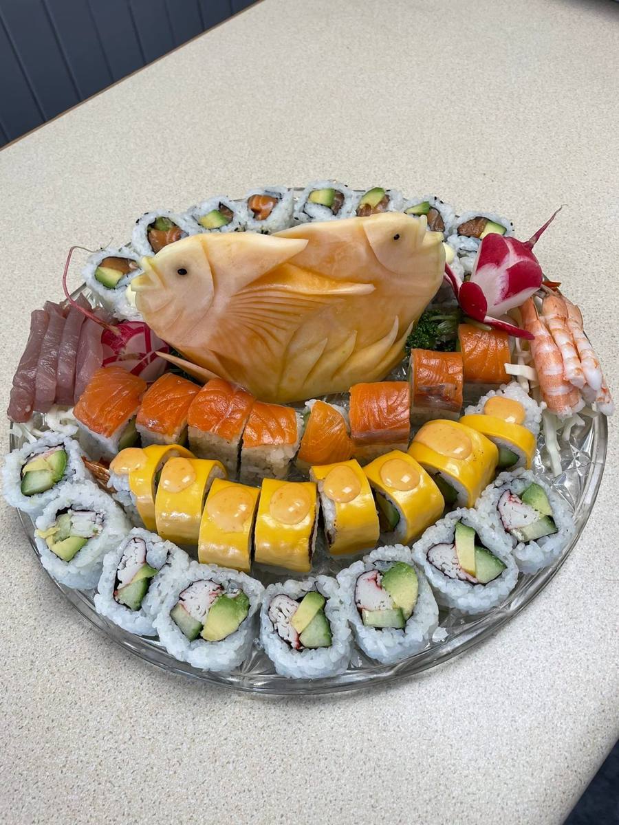 Party sushi platter with hand-carved melon fish